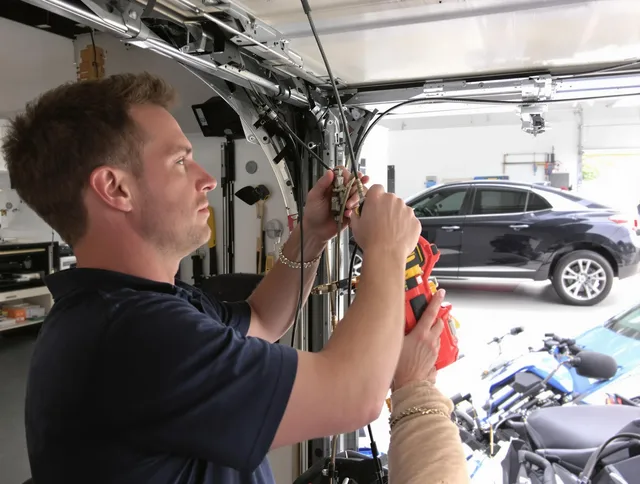 New London Garage Door Repair safety certified technician performing cable replacement in New London