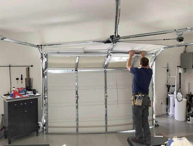New London Garage Door Repair specialist performing precise section replacement on New London garage door